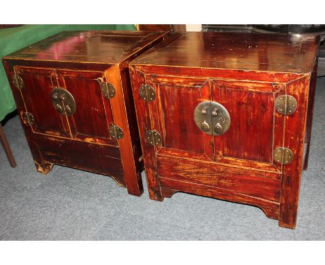 A pair of Chinese 'rosewood' cabinets, two panel doors enclosing one shelf, on square legs, 66cm, (BSF)