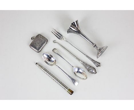 A Victorian silver bud vase, a silver vesta case, a silver toasting fork, two silver spoons, a silver handled button book and