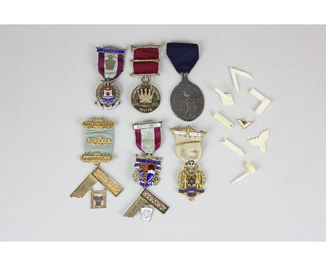 Four silver gilt Masonic medals, a set of ivory miniature Masonic items including a ruler, set square, calipers, trowel, toge