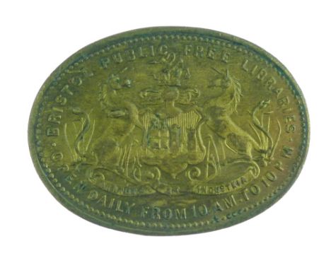 Early 20th Century oval brass library ticket for the Bristol Public Free Libraries decorated in low relief with the Bristol C