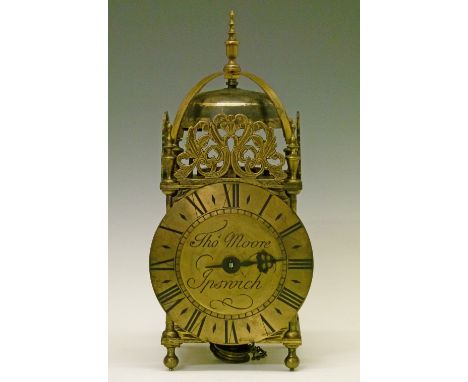 17th Century style brass lantern clock, the pierced frets with stylised foliate decoration, dial with Roman numerals and scri