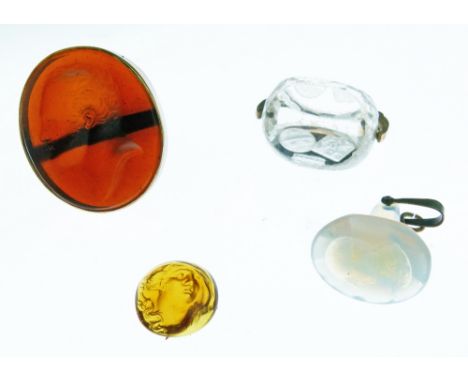 Carved intaglio amber glass oval portrait of a gentleman, now mounted as a ring, 3.5cm high, a small oval amber intaglio glas