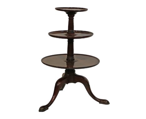 George III mahogany three tier dumb waiter fitted three circular graduated platforms and standing on a pillar and tripod base