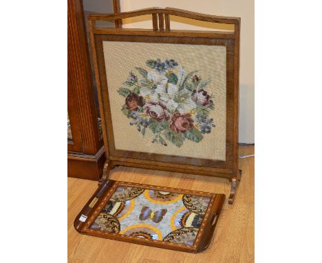 A needlepoint oak firescreen, decorated with roses, 70cm high x 56cm wide, together with a wooden tray decorated with butterf