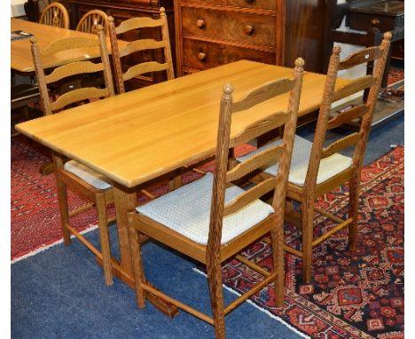 A pine Ercol refectory style table, with four ladder back chairs, table 73cm high x 137cm long x 77cm wide, chairs 98cm high 
