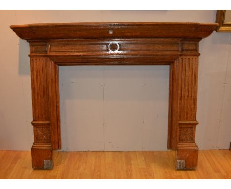 A vintage carved oak fire surround, with carved floral cartouche to the frieze, insert 97.5cm x 100cm, total height and width