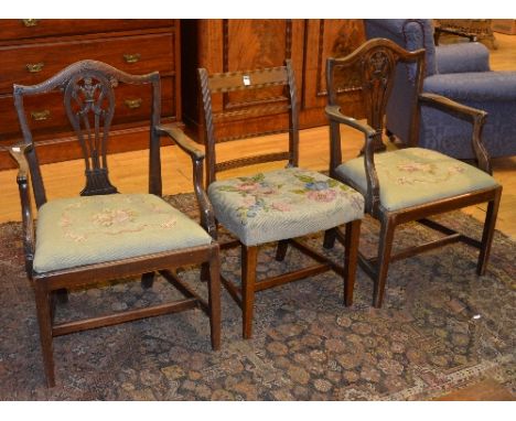 A pair of oak and needlepoint carvers, the serpentine back rail above central pierced splat with fleur de lys carved decorati