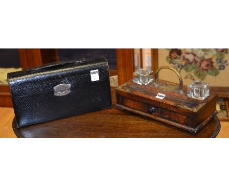 A Victorian oak brass mounted deskstand, fitted with two glass inkwells to either side of brass carry handle, quill/pen tray 