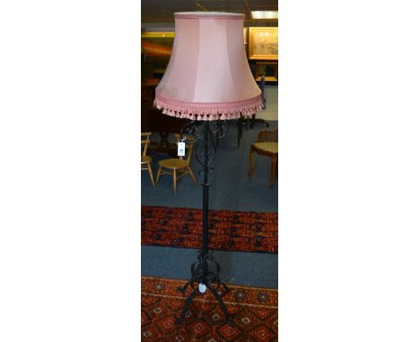 A wrought iron floor lamp with shade, 152cm high