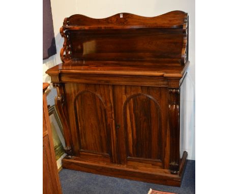 A Victorian rosewood chiffonier, with shelved gallery back above drawer and two panelled doors, flanked with a scroll column 