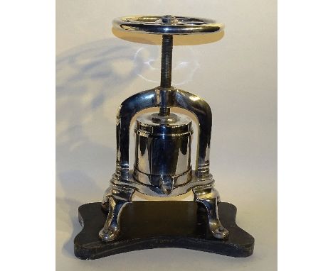 A silver plated duck press, of plain design raised on wooden plinth, appears to be in working order, 56cm high to wheel fully