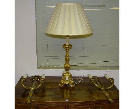 A pair of gilt metal wall sconces in the antique style, 60cm high, together with a gilded table lamp with shade (3)