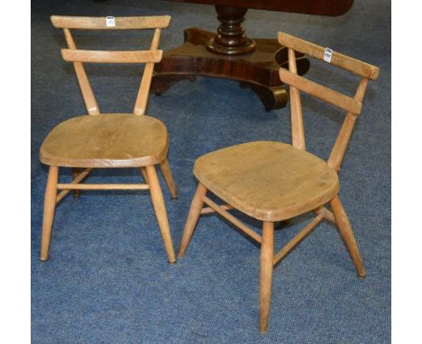 A pair of vintage Ercol child's stacking chairs, with bar back, above solid seat, raised on spindle supports, yellow dot mark