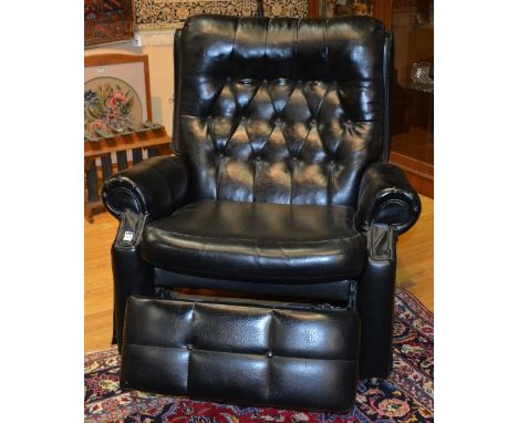 A vintage black leather reclining armchair, 97cm high