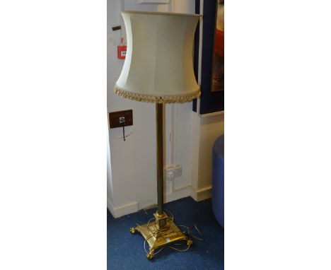 A brass Corinthian style floor lamp with shade, raised on fluted column and platform base with ball and claw supports, 123cm 