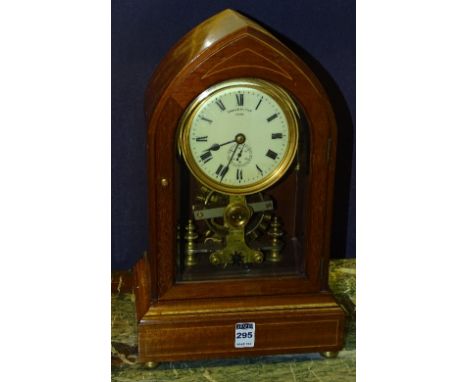An early Eureka electric mahogany lancet form mantel clock, circa early 20th century, the 4.5 inch cream enamel dial with Rom