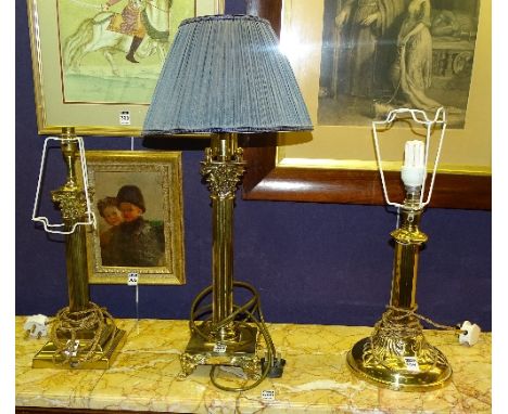 Two brass Corinthian style table lamps, one with shade, 33 & 40cm high, together with an Arts & Crafts brass table lamp (3)  