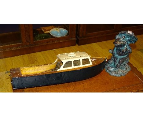A vintage wooden pond yacht, 66cm long, together with a statue of a frog, 34cm high (2)