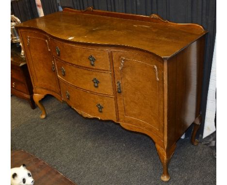 A vintage walnut sideboard, with three central drawers, flanked with a panelled door, raised on cabriole supports, 90cm high 