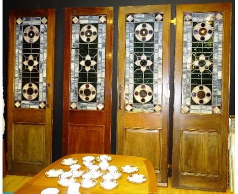 A set of four stained and leaded panels by Edinburgh Stained Glass House 2000, richly coloured in the Art Nouveau style, fitt