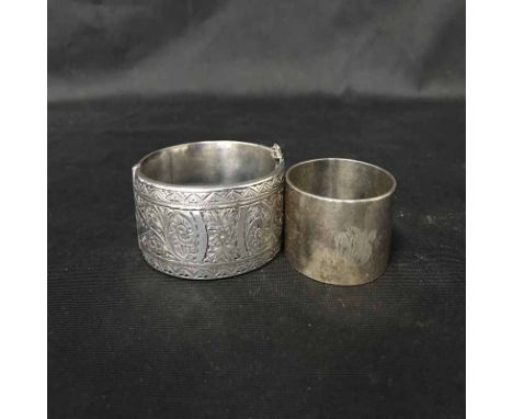 SILVER BANGLE WITH ENGRAVED DECORATIONmaker Smith & Pepper Ltd, Birmingham 1948, along with a napkin ring 