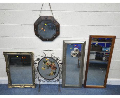 A WROUGHT IRON FIRE SCREEN, fitted with an oval mirror, depicting flowers, height 89cm, a gilt resin bevelled edge wall mirro