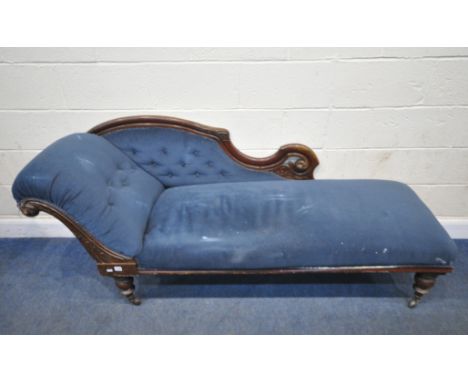 A VICTORIAN BLUE FABRIC UPHOLSTERED CHAISE LOUNGE, with a scrolled end, a shaped buttoned raised back, raised on turned legs,
