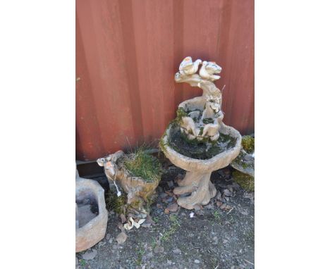 TWO MODERN CONCRETE GARDEN ORNAMENTS, one in the form of a tree stump cascade with Doves atop, height 86cm (repair to top ste
