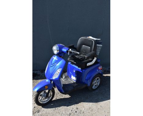 A VELECO ZT15 BLUE THREE WHEELED SCOOTER, with two chargers, waterproof cover and manual, condition report: there is damage t