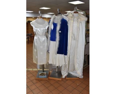 A COLLECTION OF VINTAGE WEDDING DRESSES, comprising a cream satin long sleeved wedding dress with a fur trimmed hooded cape w