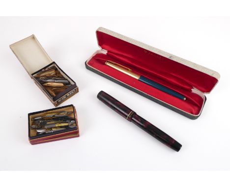 A cased Parker 65 fountain pen in teal blue with striped rolled gold cap and 14k nib; together with a 1930s red and black mar