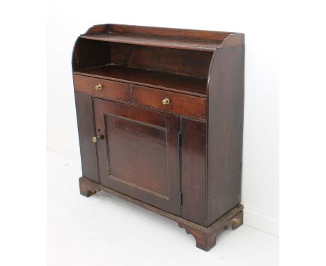 A George III oak side cabinet - the waterfall two-shelf top over a pair of drawers and a single panelled cupboard beneath, en