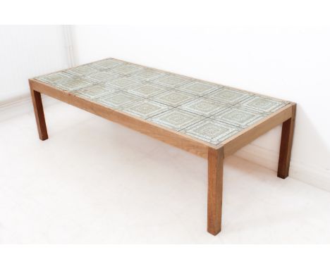 A 1970s retro tile-top coffee table - the large rectangular top inset with three rows of seven ceramic tiles, glazed in grey-