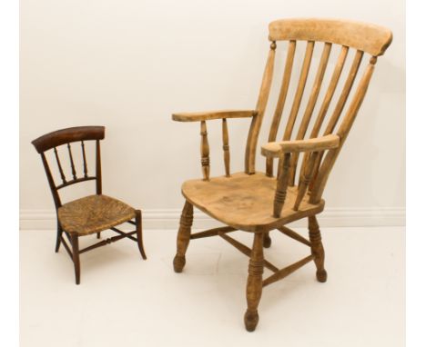 A late 19th century stripped beech and elm lathe-back chair - with slat back and swept arms over a saddle seat, on ring turne