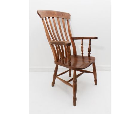 A late 19th / early 20th century lathe back chair - in beech and oak with a plain 5-slat back and oak saddle seat, on ring tu