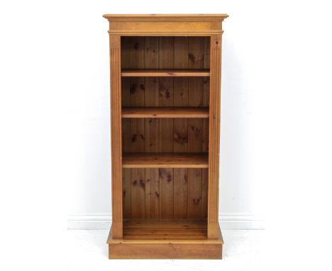 A pine three shelf open bookcase - with adjustable shelves and fluted stiles, on a plinth base. (LWH 66.5 x 38 x 136.5cm.)