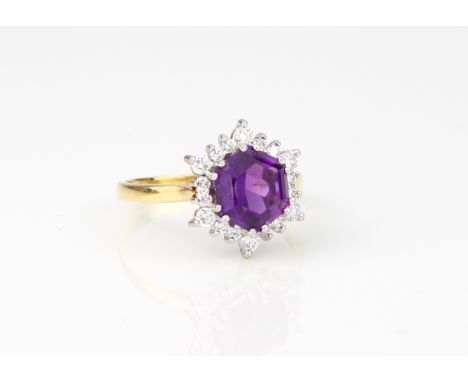 An 18ct yellow gold, amethyst and diamond cluster ring - hallmarked London 2008, the approx. 13.5mm. hexagonal cut amethyst o