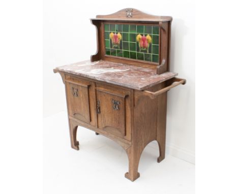 An Arts and Crafts oak and marble tile-back washstand in the manner of Liberty - the tiled camel back with a central stylised