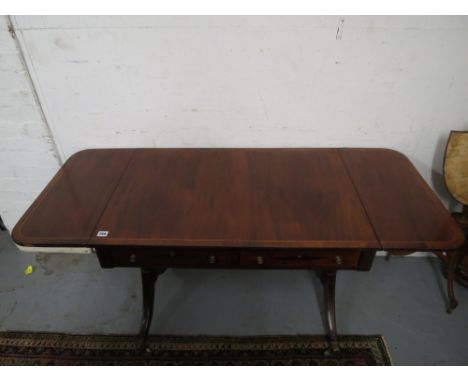 A Regency string inlaid mahogany sofa table with a pair of short drawers with facsimiles on the reverse over opposing twin tu