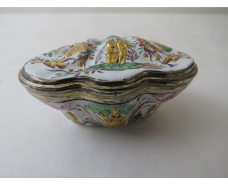 A late 18th century French enamelled silver gilt patch box of shell design decorated with urns of flowers, eagles, swags and 