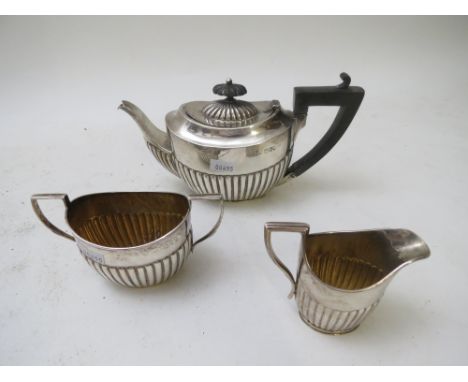 A late Victorian silver teapot London 1895, together with a silver sugar bowl London 1894, and a milk jug Birmingham 1890. To