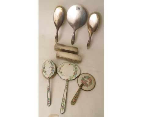 A silver backed dressing table set with engine turned decoration, dated Birmingham 1924, together with two other hand mirrors