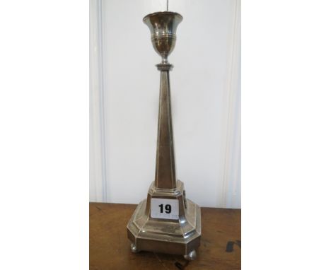 A Swedish silver candlestick by Zethelius of octagonal form having an applied mask ornament on four feet, 9 1/2 high. Total w