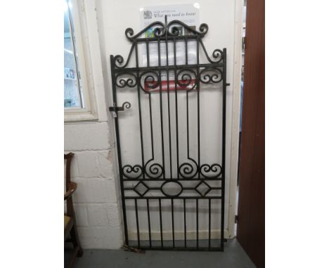 A 20th century black painted wrought iron garden gate with bar and scrolled ornament 74 x 35 1/2