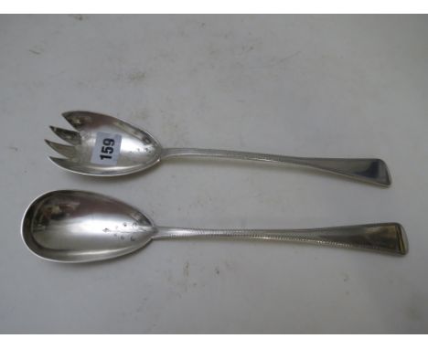 A George III silver salad serving spoon by TH London 1807, together with a William IV silver salad serving fork Exeter 1835. 