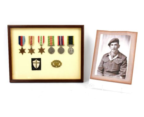 World War II group of five medals framed with a Territorial medal, Warrant Officers Class II badge and shoulder patch, awarde