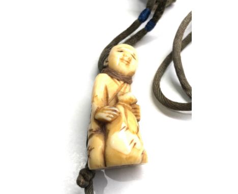 Antique ivory netsuke on original cord 