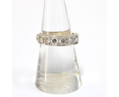 An 18ct white gold  diamond ring, set with a row of seven graduating diamnds, stamped 750