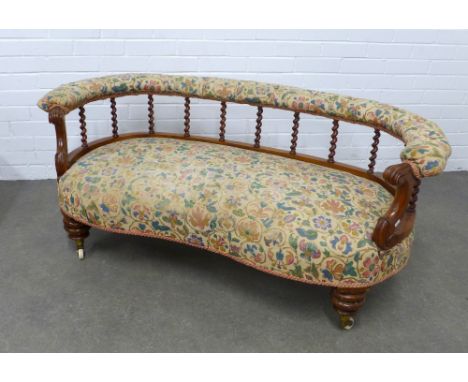 A Victorian upholstered two seater settee / window chair, curved back with barley twists supports, scroll arms and serpentine