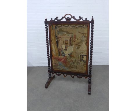 19th century tapestry screen in a pierced mahogany frame with spiral supports, 85 x 138cm.